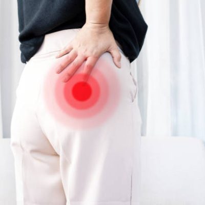 Piriformis syndrome concept with woman suffering from buttock muscle pain when sitting