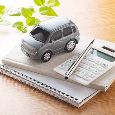 Toy car and calculator on the table. Toy car and calculator on the table.